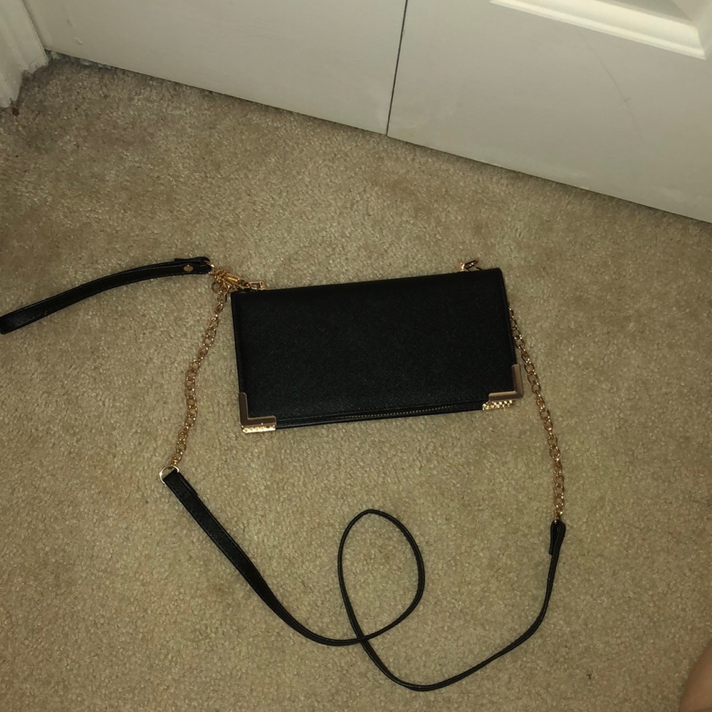 Black Wallet/wristlet with a crossbody chain. Never used